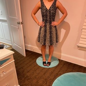 Black and gold fit and flare dress. Made by Gig.